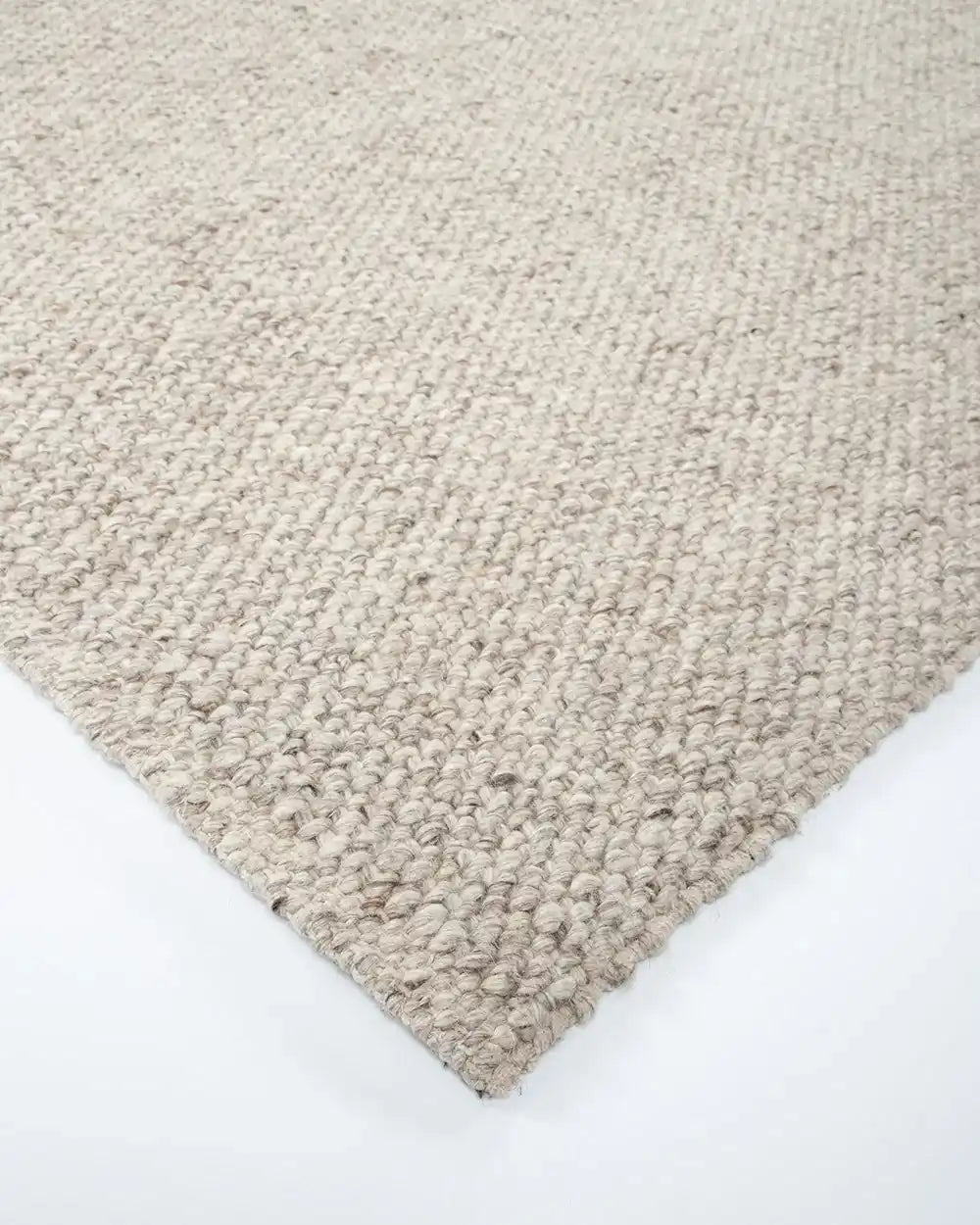 Corner of the Baya woven textural floor rug 'Omaha' in colour 'Pebble'