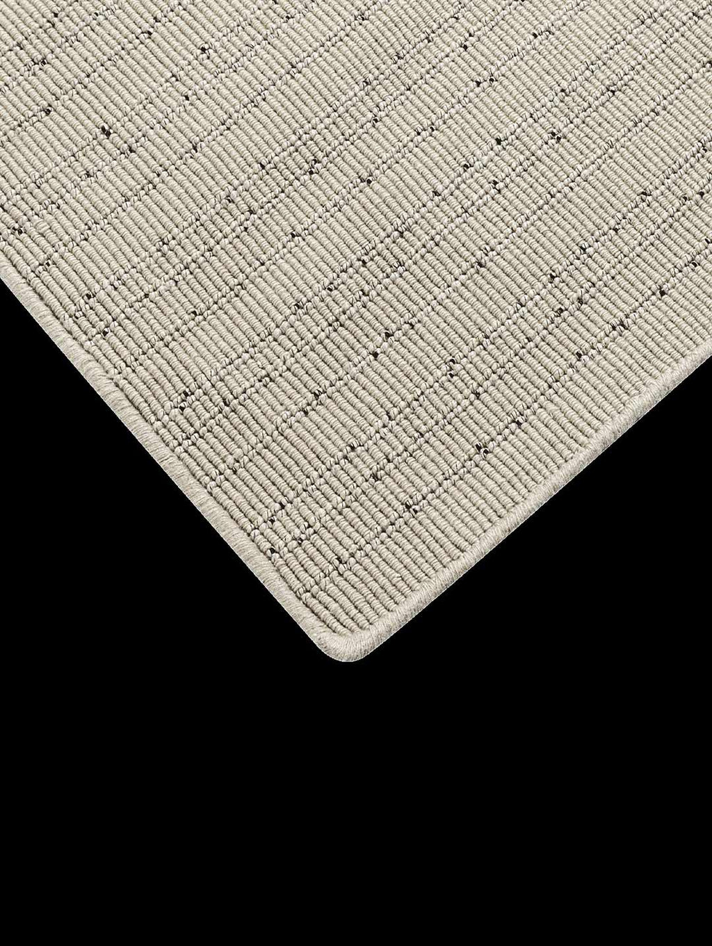 Corner of the Tribe Home Fritz floor rug , in colour ivory, seen from above - close up