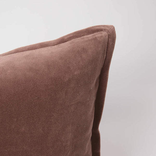 A corner image of a velvet long lumbar cushion, in a muted clay pink by Eadie Lifestyle