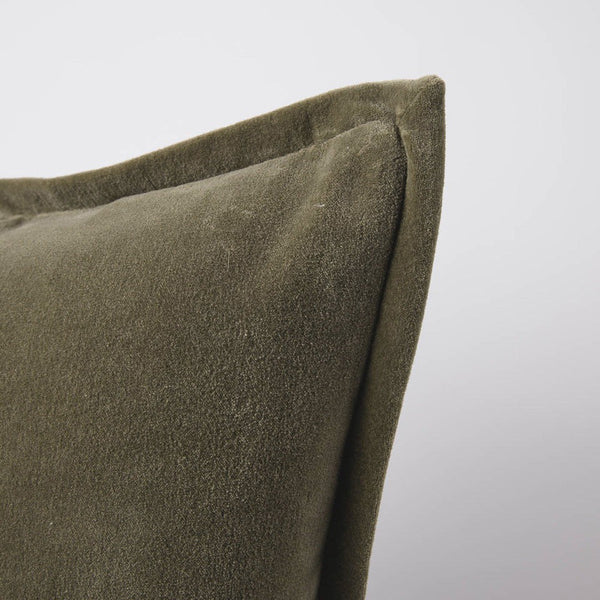 A corner image of a velvet long lumbar cushion, in a warm olive-green tone by Eadie Lifestyle