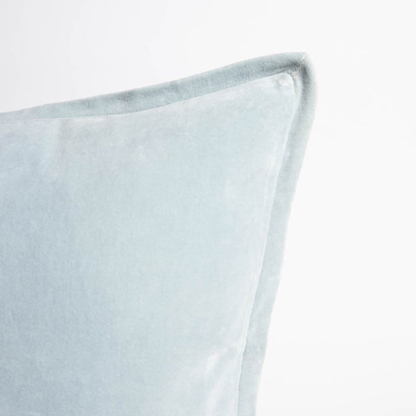 A corner image of a velvet long lumbar cushion, in a delicate sky blue by Eadie Lifestyle