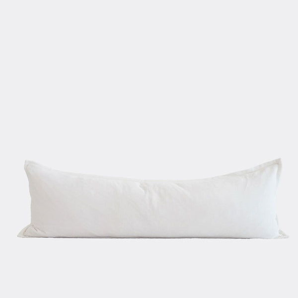 A full image of a long lumbar cushion in a sweet off-white shade, in velvet fabric by Eadie.