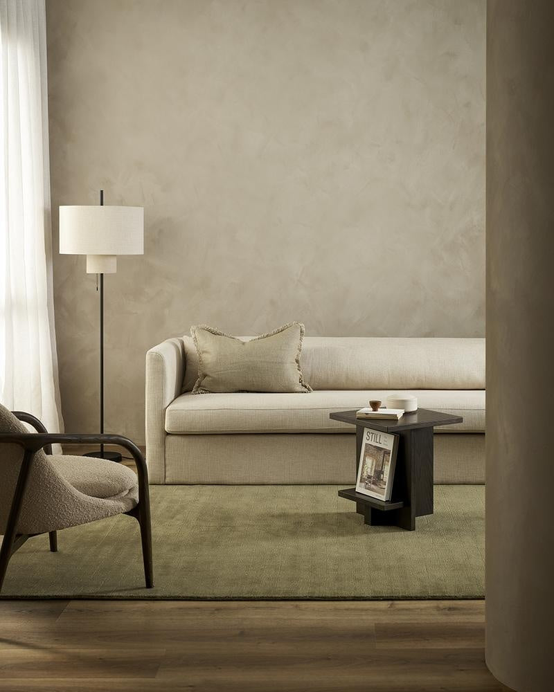 The exquisite Haywood green 'Lichen' New Zealand wool tip-sheared floor rug in a modern living room