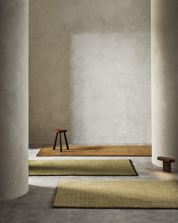 Three colours in the Sandringham wool runners rug by Baya, seen in a modern home with wooden floorboards.