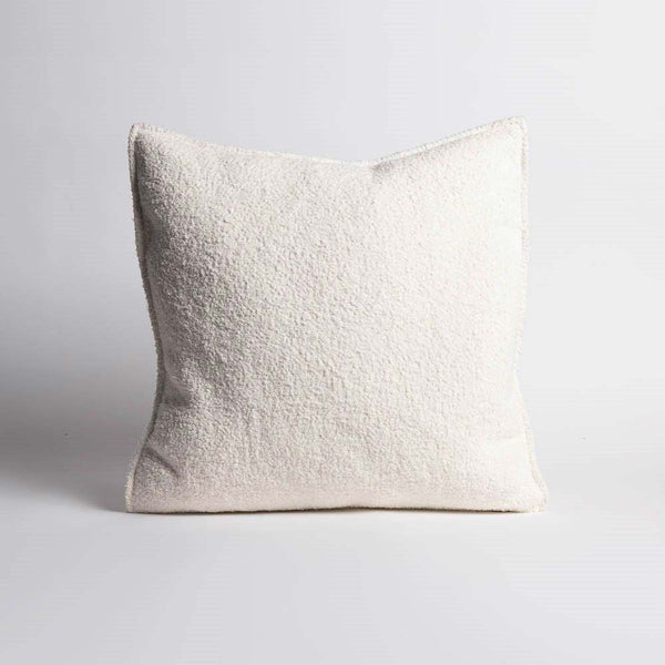 A crisp textured white cushion with a small flange edge, by Eadie Lifestyle