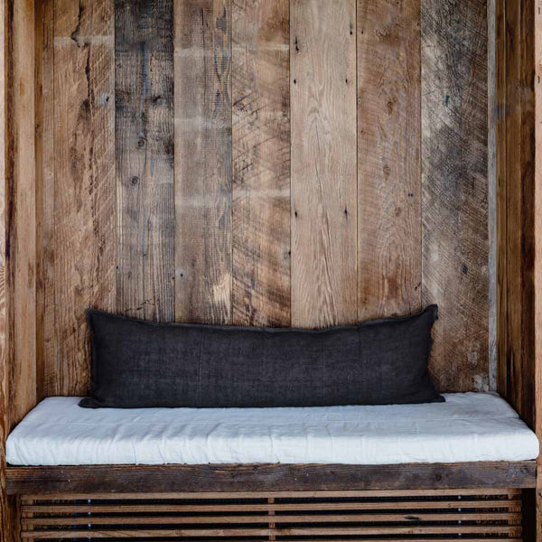 A long lumbar cushion in Midnight blue, made with natural linen and with a delicate flange edge and hem detailing.