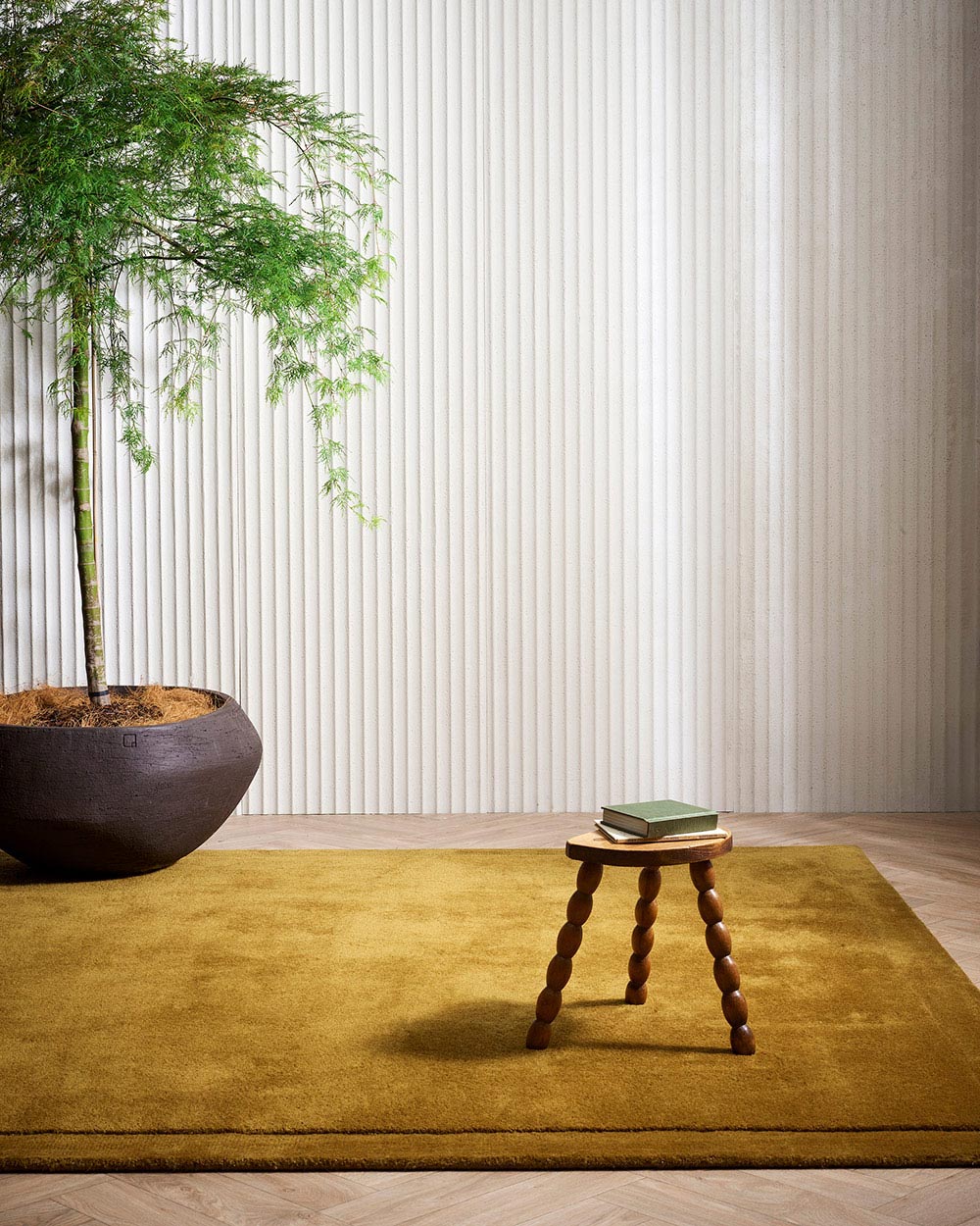 A minimalist living room with a gorgeous cut pile 100% New Zealand wool in a statement brass ochre colourway.