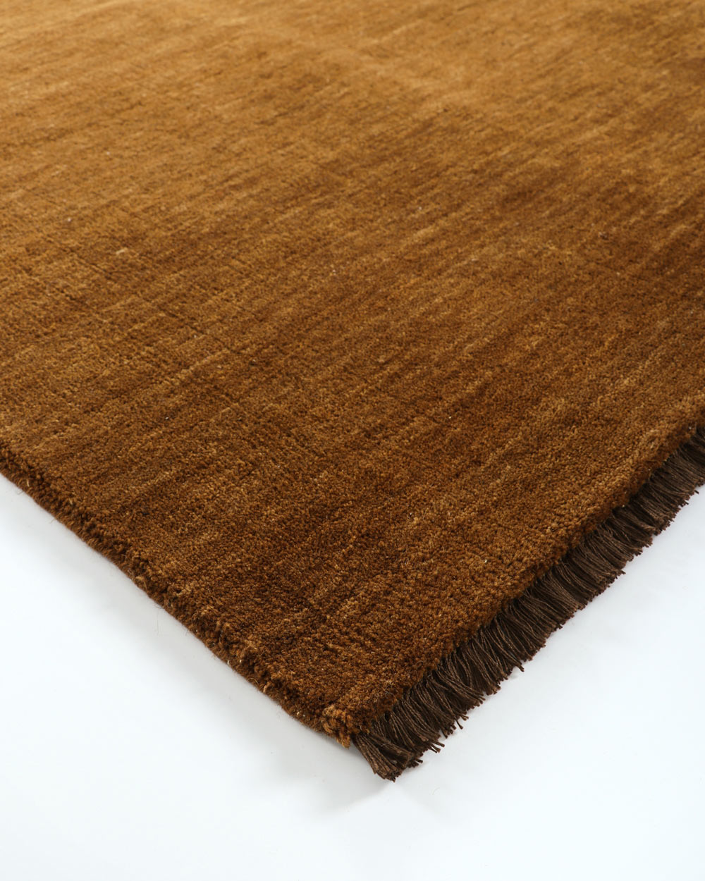 A corner image of the Pecan rug in 100% wool by Baya.