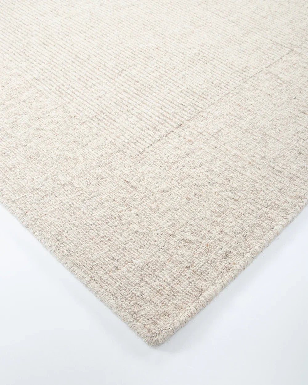Close up corner shot of the Baya wool rug 'Vermont' in neutral colour 'Sand