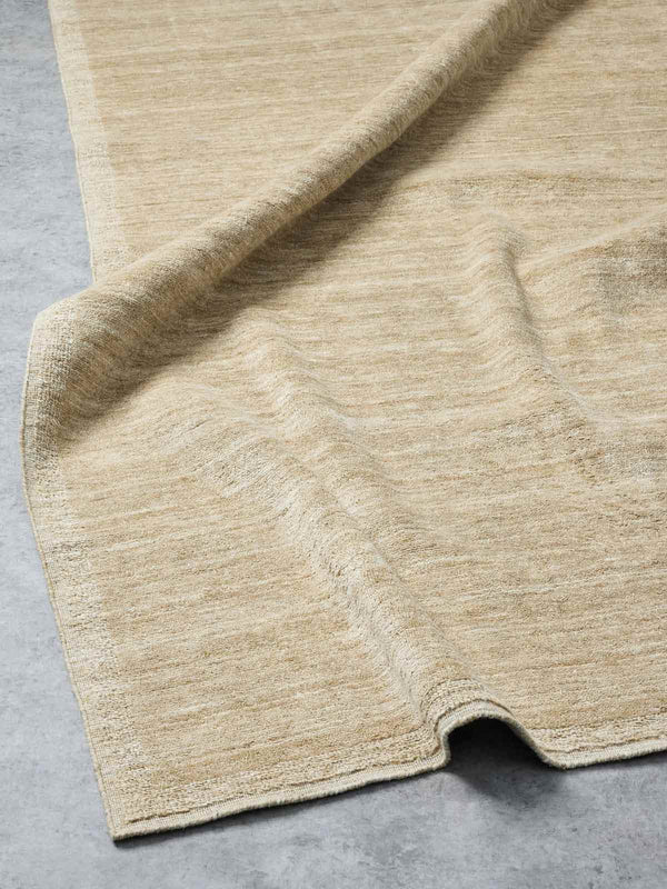 A handloomed, 100% NZ wool floor rug in camel and beige tones, by Tribe Home