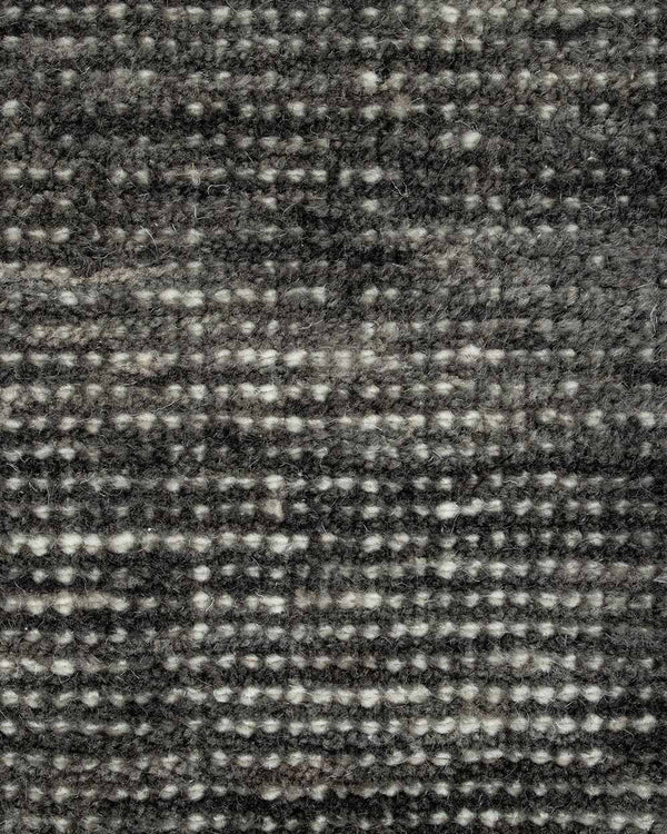 A close up image of a handloomed charcoal toned floor rug in 100% New Zealand Wool by Baya