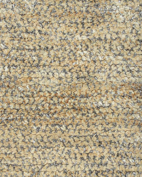 A close up of the weave of the Fairbanks floor rug, an effortlessly luxurious bamboo silk and jute blend. The warm brown of the jute blends with the soft beige of the silk in a beautiful medley.