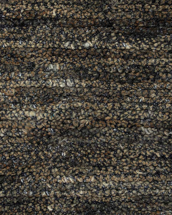 A close up of the weave of the Fairbanks floor rug, an effortlessly luxurious bamboo silk and jute blend. The warm brown of the jute blends with the soft greys of the silk in a beautiful medley.