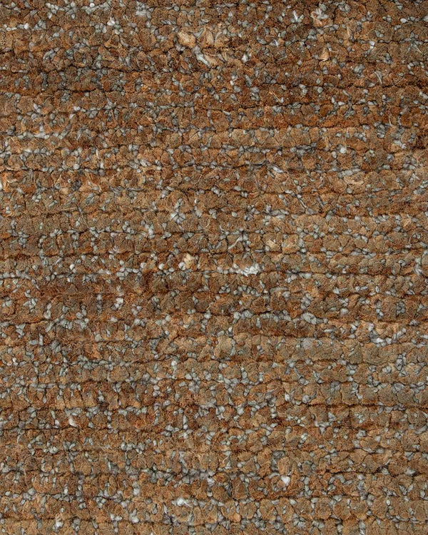 A close up of the weave of the Fairbanks floor rug, an effortlessly luxurious bamboo silk and jute blend. The warm brown of the jute blends with the honey tones of the silk in a beautiful medley.