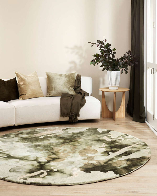 A beautiful green patterned round rug by Baya NZ in a modern living room.