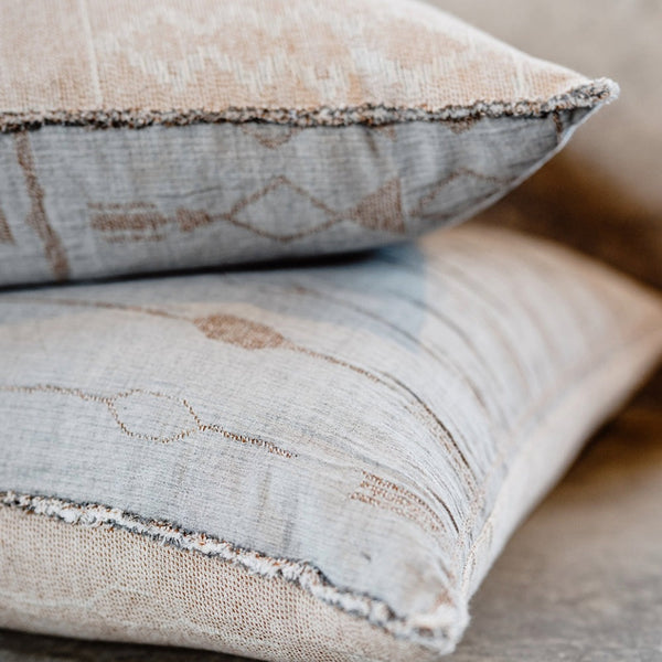 Two of the Kasumi patterned cushions by Eadie Lifestyle, with delicate fringing on the edges.