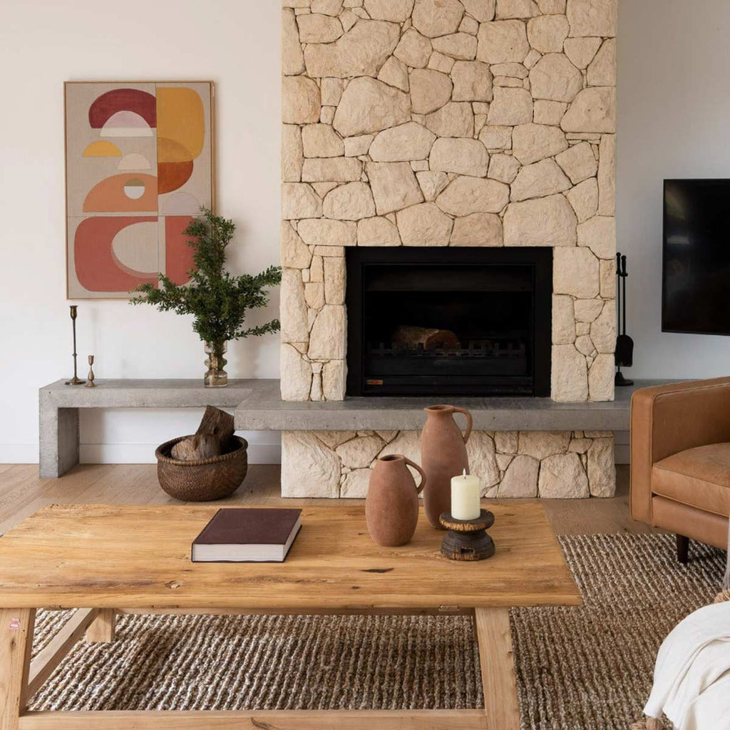 A large bohemian style living room with a textural light brown and white jute floor rug.
