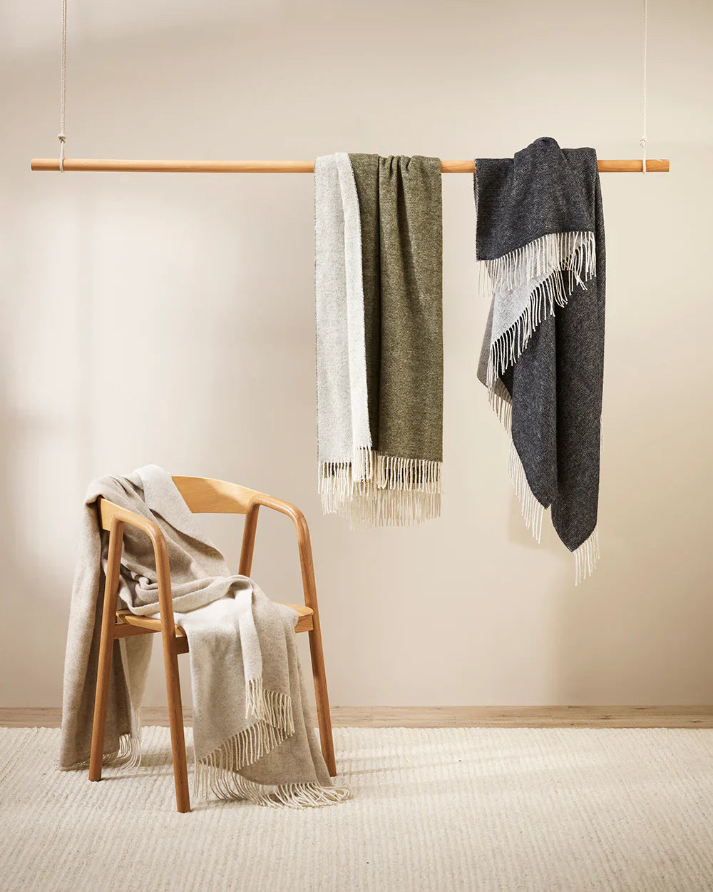 A collection of neutral merino throws draped in various ways