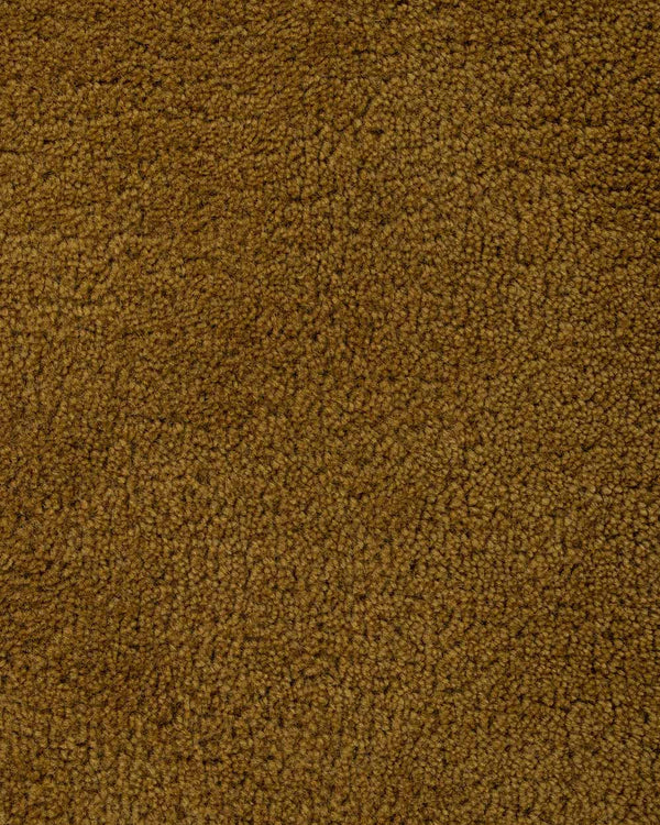 A close up of the weave of the Norfolk floor rug in Brass. The luxurious depth of the pile and sumptuous golden caramel colour make this rug a standout.