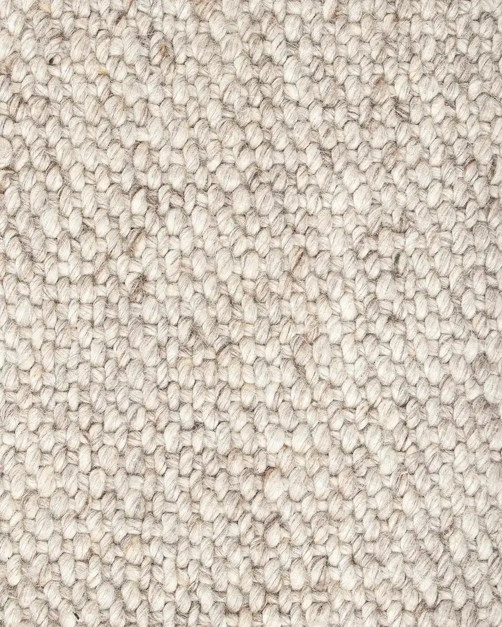 Close up of the Baya woven textural floor rug 'Omaha' in colour 'Pebble'