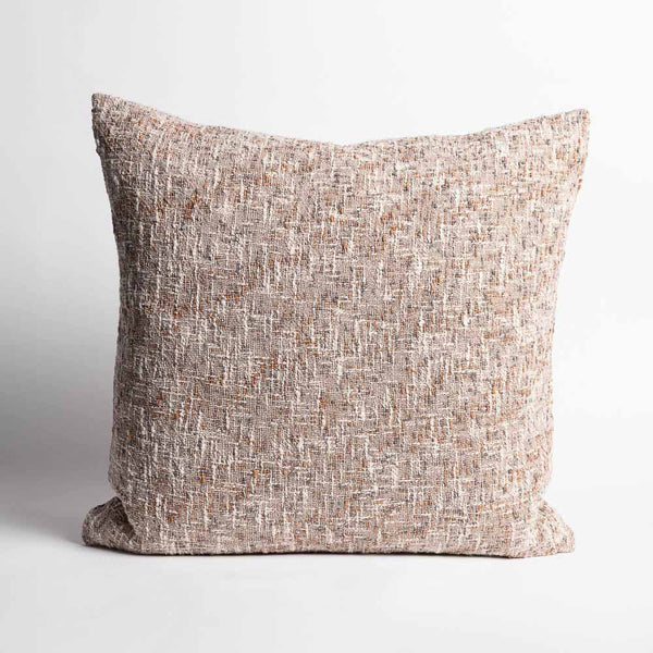 A richly textured, 100% cotton cushion in warm clay tones