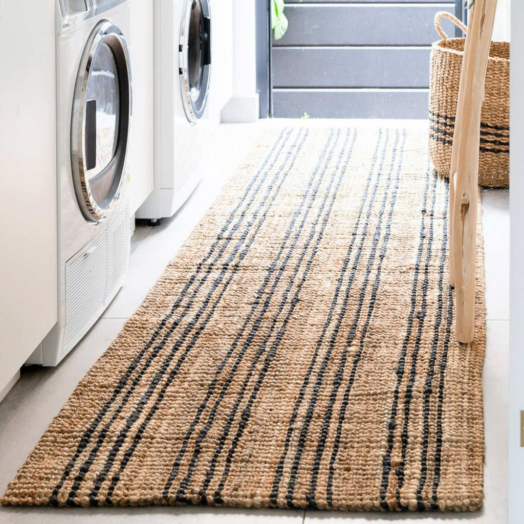 A laundry area with a hand knotted black and brown striped floor runner made of natural jute fibres.