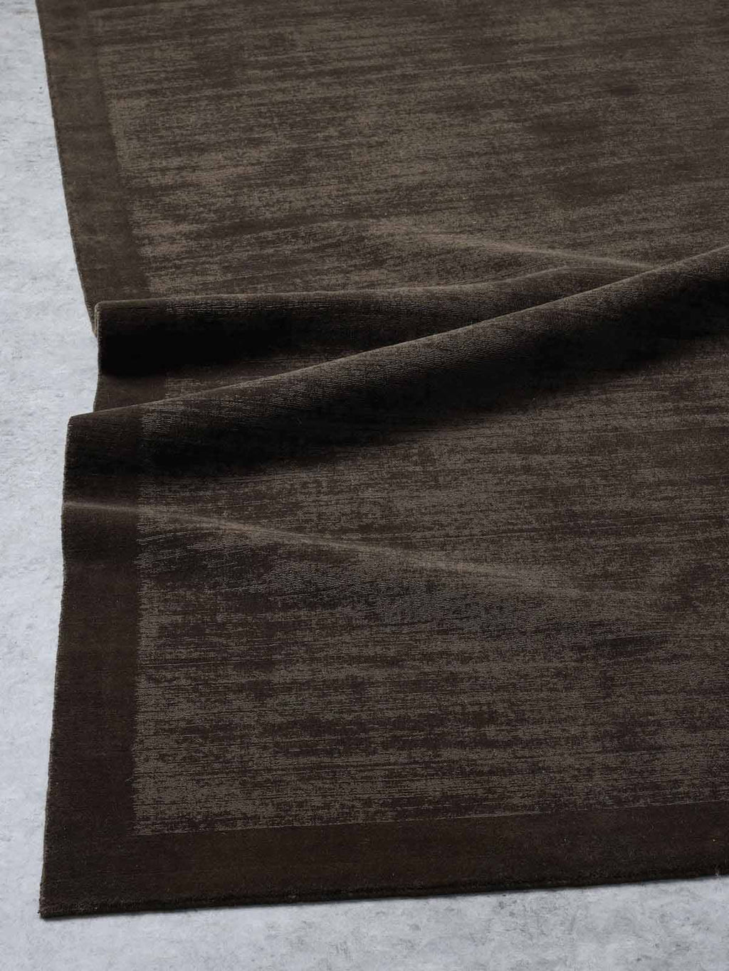 A beautiful chocolate brown rug made with 100% New Zealand wool by Tribe Home