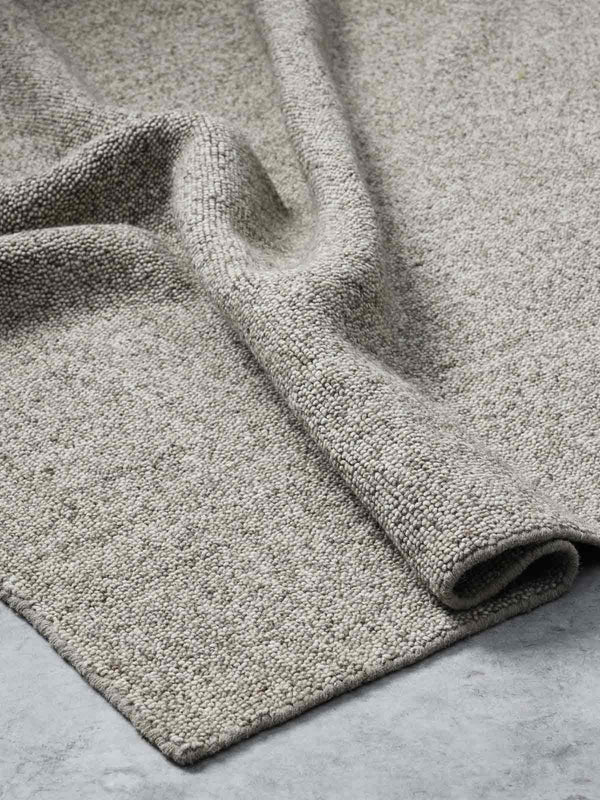 A dark beige warm, looped style 100% wool floor rug from Tribe Home