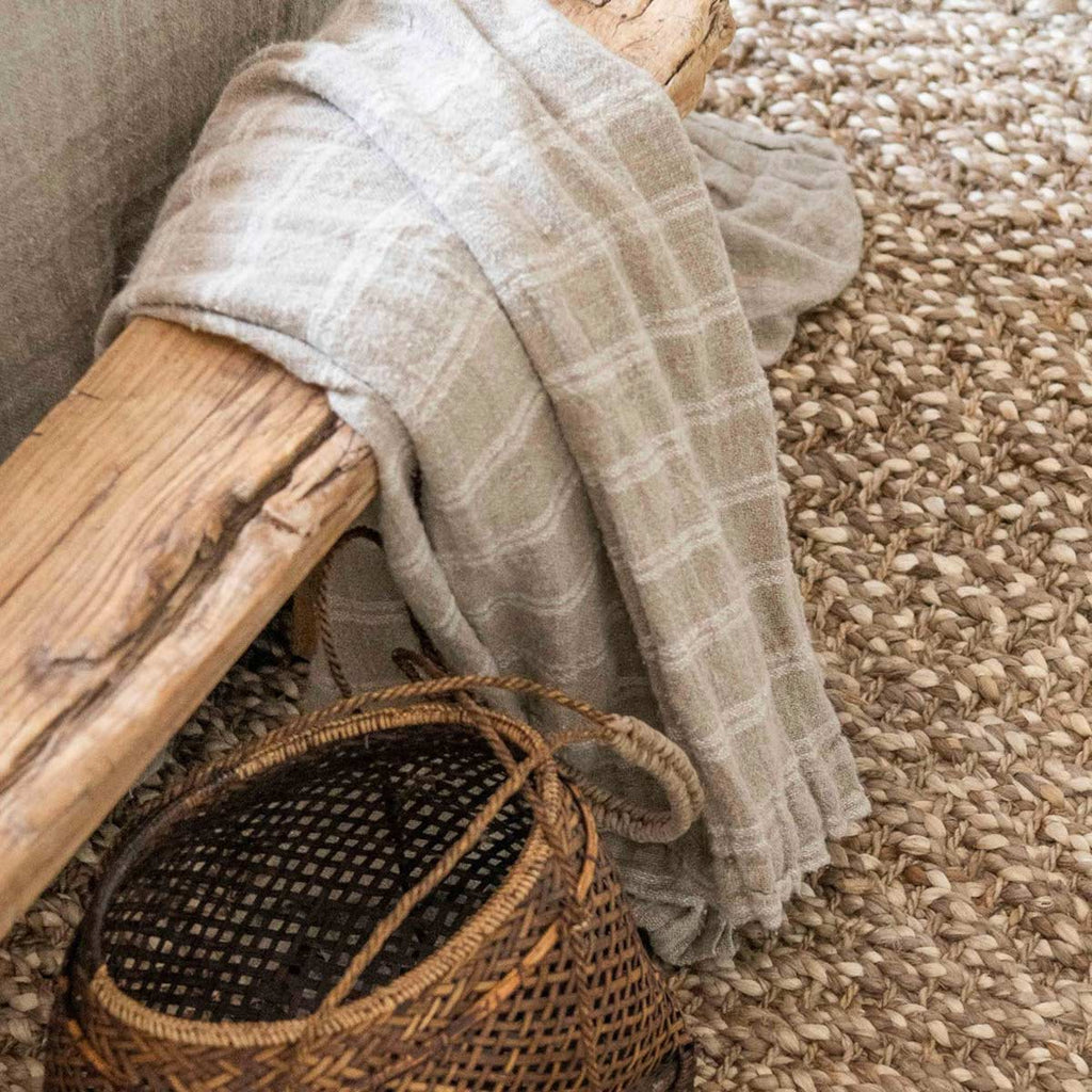 A close image of the boucle twisted pattern of a light brown jute floor rug.