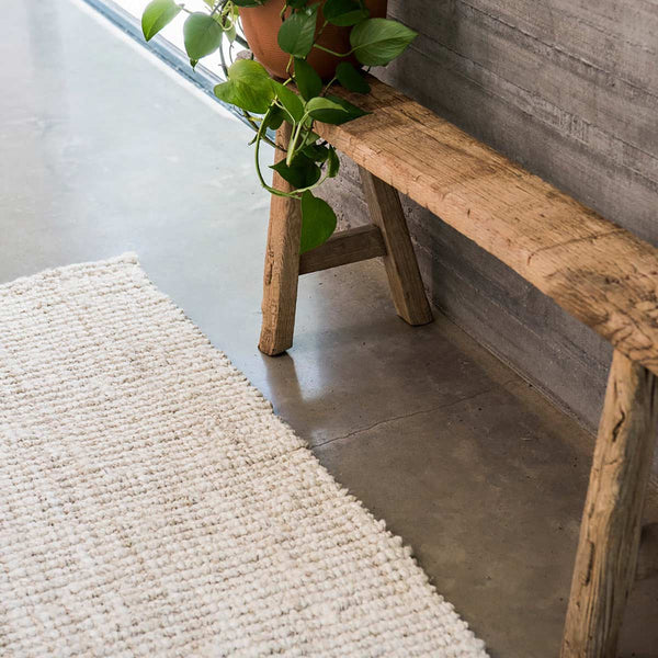 A hallway runner made from simple white washed jute fibres in a boucle weave.