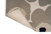Marimekko hallway runner rug with floral patterned on beige with corner folded up to see backing
