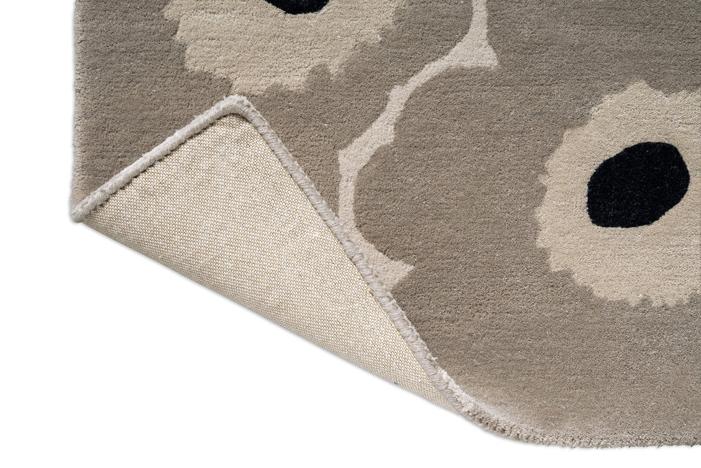 Marimekko hallway runner rug in NZ wool with floral patterned design and corner folded to reveal backing