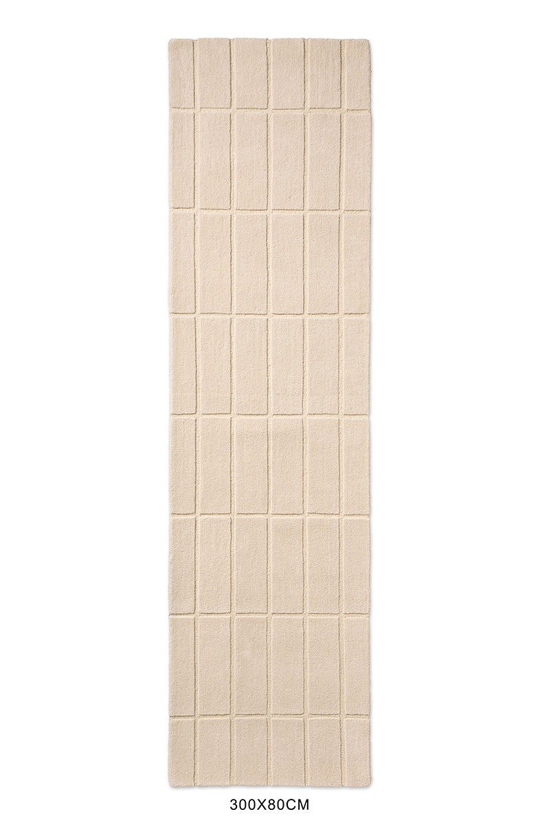 A Marimekko grid patterned runner rug in a neutral creamy white 
