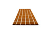 A Marimekko NZ wool checked rug in an on-trend rusty orange colour
