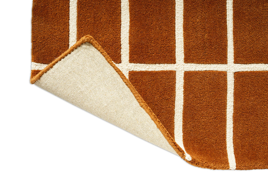 Close-up of a brown and beige checkered rug corner