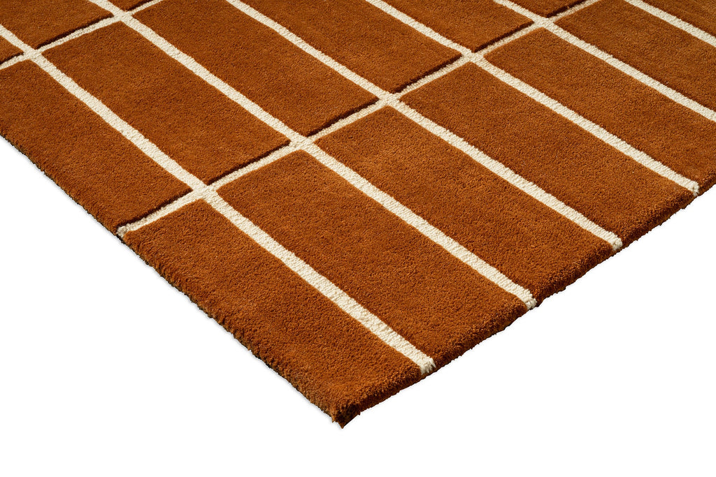 Corner view of a Marimekko NZ wool rust grid patterned rug