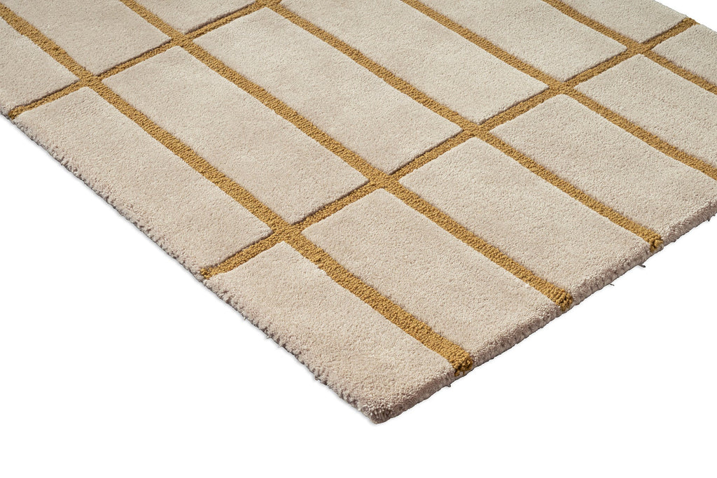 Corner view of a Marimekko NZ wool beige runner rug with gold grid pattern 