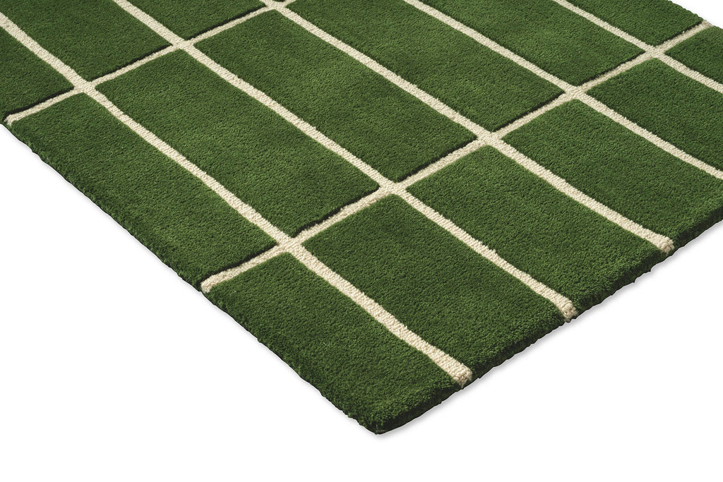 Corner view of a green grid-style Marimekko NZ wool runner rug 