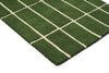Corner view of a green grid-style Marimekko NZ wool runner rug 