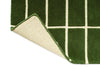 Corner of a green geometric Marimekko NZ wool runner rug showing the backing