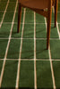 Green geometric Marimekko NZ wool rug with wooden chair legs on top