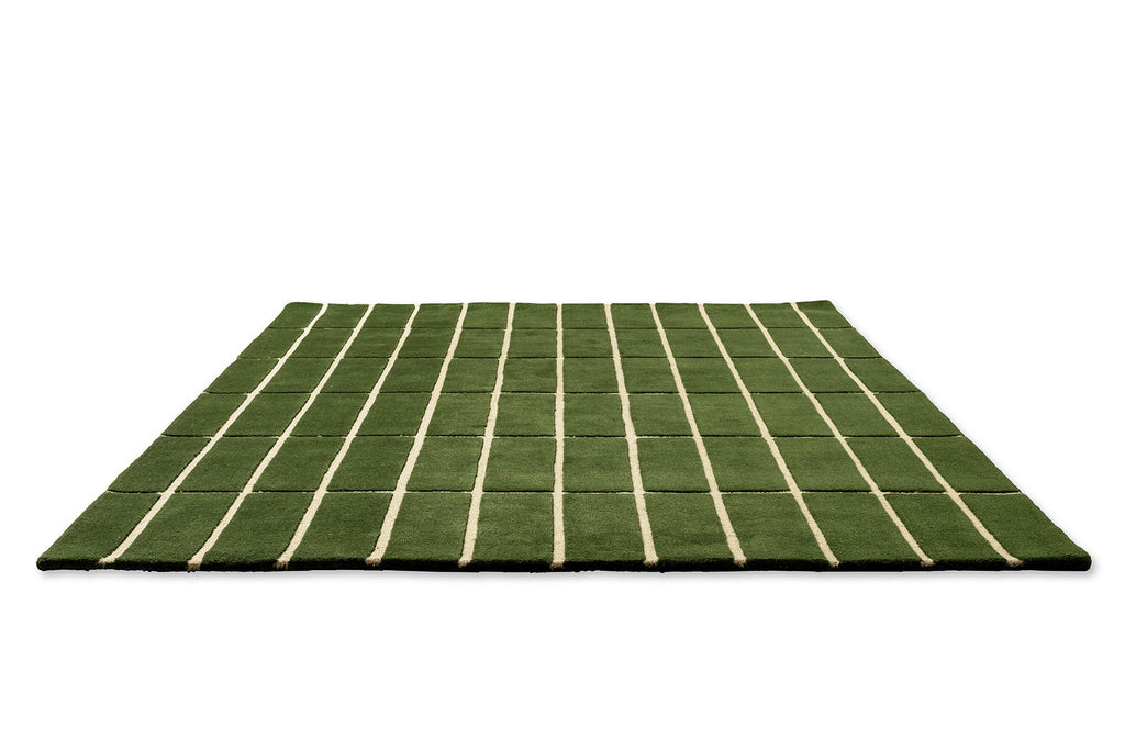 Perspective view of a green geometric Marimekko NZ wool rug 