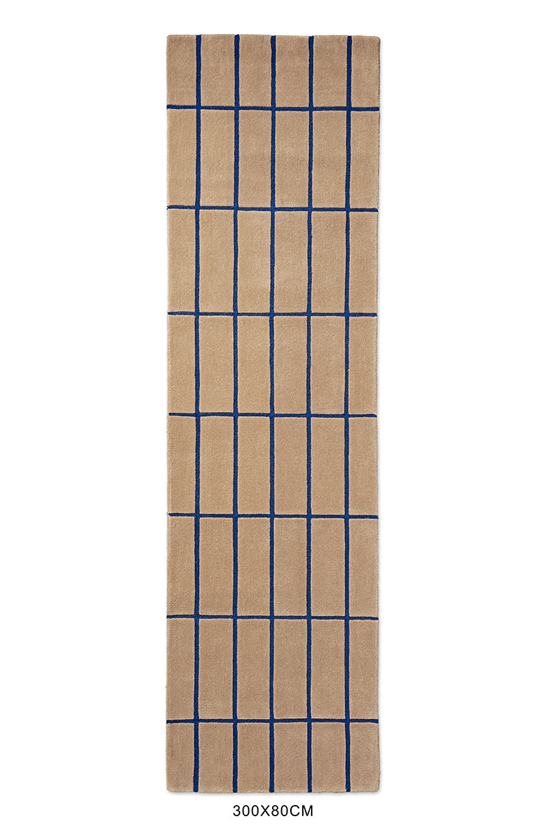 Full view of a Marimekko NZ wool runner rug with blue grid pattern on a beige  background