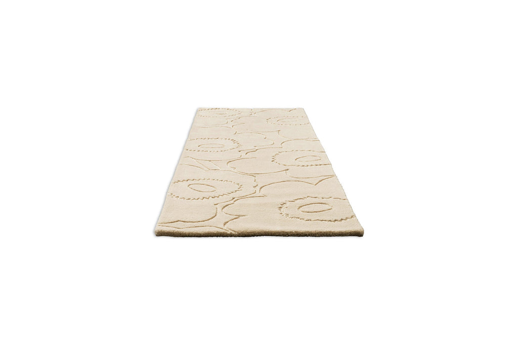 A Marimekko runner rug in a creamy white with a subtle graphic cut into it in a perspective view