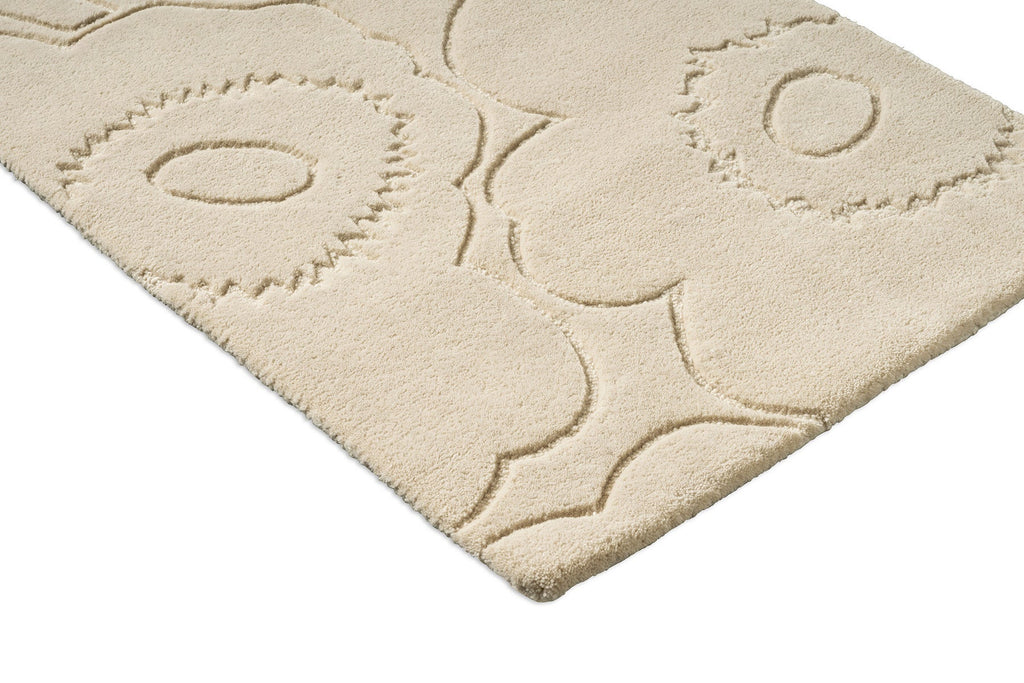 Close up of a Marimekko runner rug in a creamy white with the iconic unikko floral design cut into it