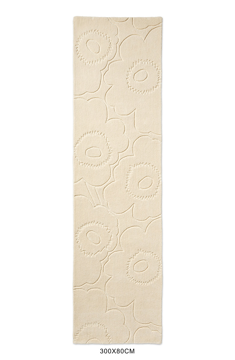 Marimekko runner rug in a creamy white with the iconic unikko floral design cut into it