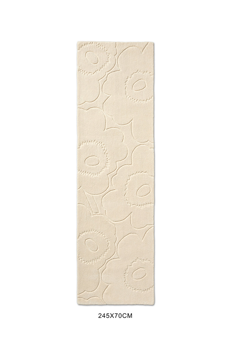 A Marimekko runner rug in a creamy white with a subtle graphic cut into it