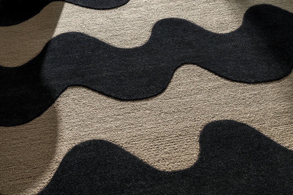 Extreme close up of Marimekko NZ wool Rug with black wavy pattern on beige background