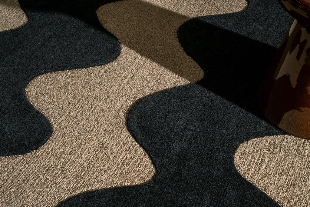 Close up of a Marimekko NZ wool Rug with black wavy pattern on beige background