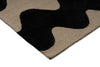 Corner close up of a Marimekko NZ wool Rug with black wavy pattern on beige background